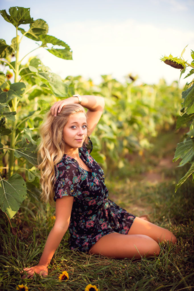 High School Senior sitting in a Sunflower field | Bask in the Beauty: Sunflower Mini Sessions