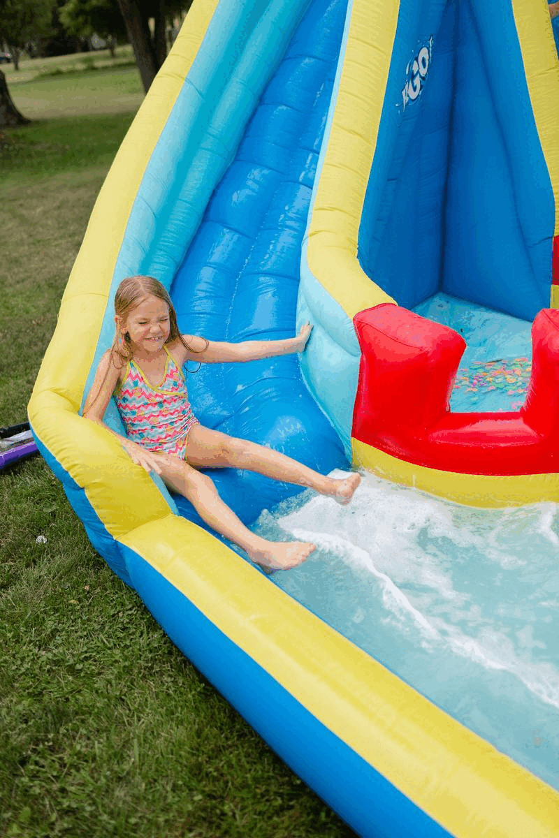 7 year old girl sliding down a water slide