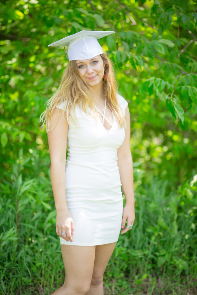 Color image of high school senior in her cap & gown.